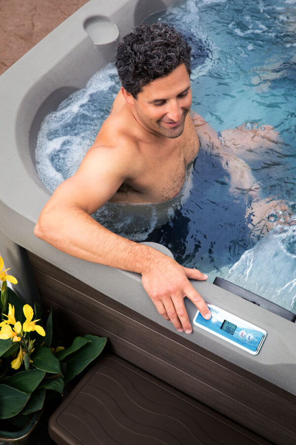 men relaxing in hot tubs while checking his phone